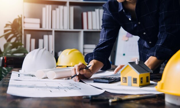 Two business man construction site engineer Engineering objects on workplace with partners interacting on background