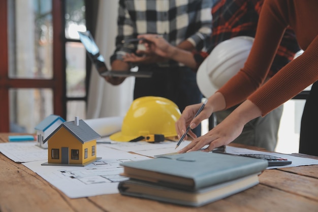 Two business man construction site engineer Engineering objects on workplace with partners interacting on background