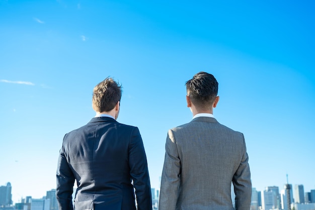 Two business men stands on fine day