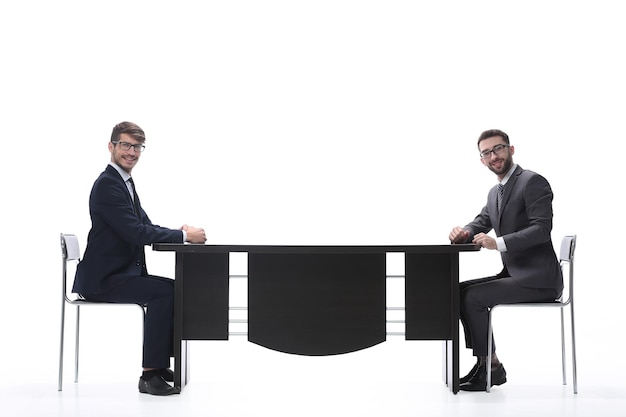 Two business people discussing something sitting at the table