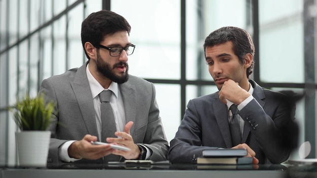 Two business people in the office at the table