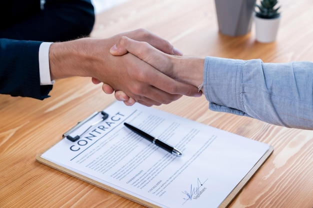 Two business people shake hand after successfully signing contract Entity