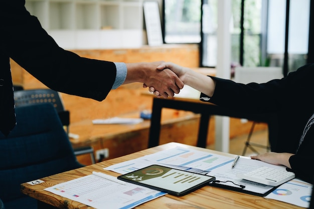 Photo two business people shake hands after accepting a business proposal together a handshake is a universal homage often used in greeting or congratulations