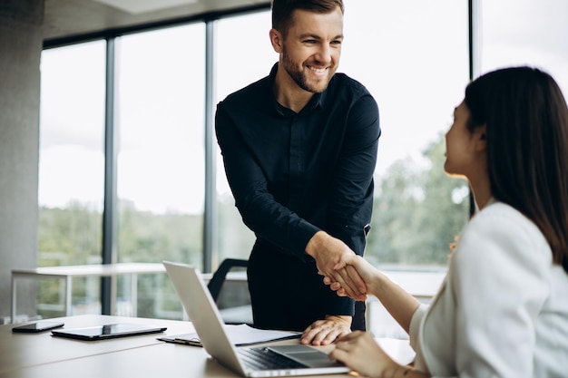 Two business people shaking hands at the office