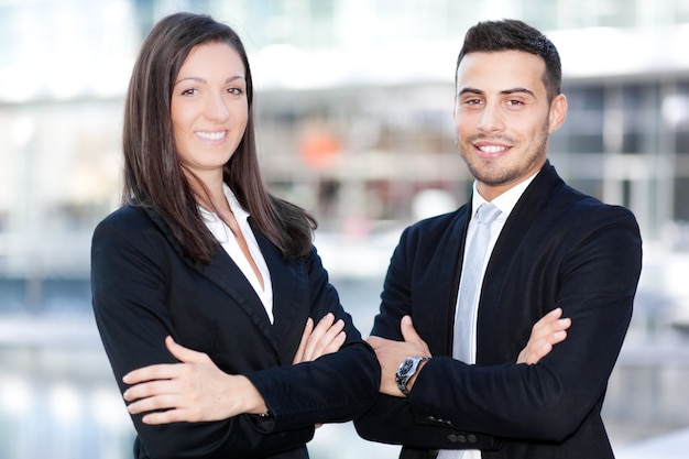 Two business people smiling in an urban setting