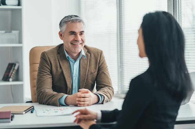 The two business people talking at the office table