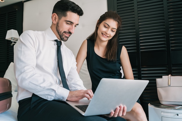 Two business people working together on laptop.