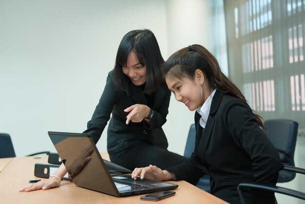 Two business woman happy concept success workDiscuss about project of workThailand people