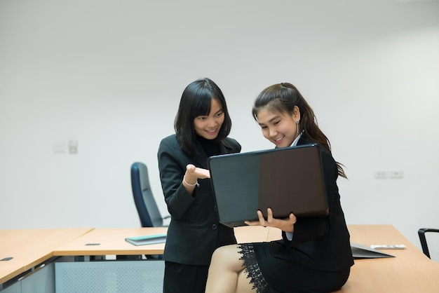 Two business woman serious about work in the officeDiscuss about project of workThailand people