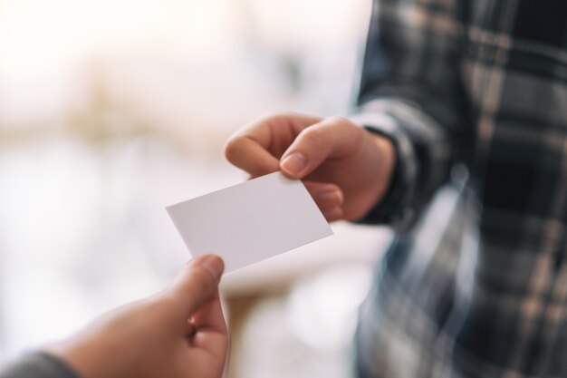 Two businessman holding and exchanging empty business card