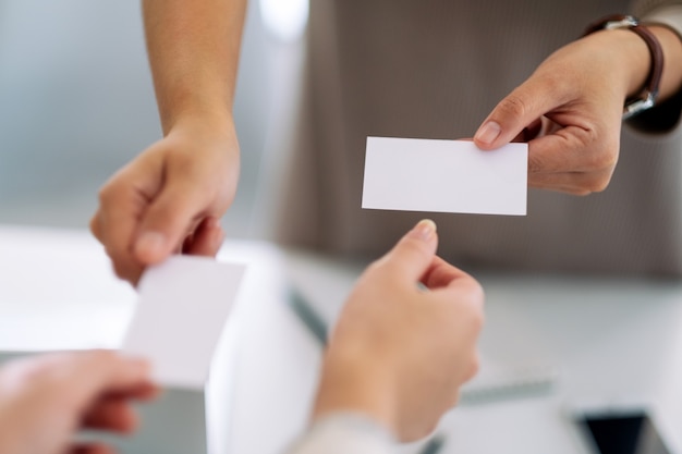 Two businessman holding and exchanging empty business card