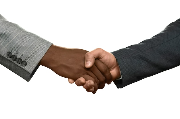 two businessman shake hands. we&amp;#39;re partners now. know your enemy. honesty or deception.