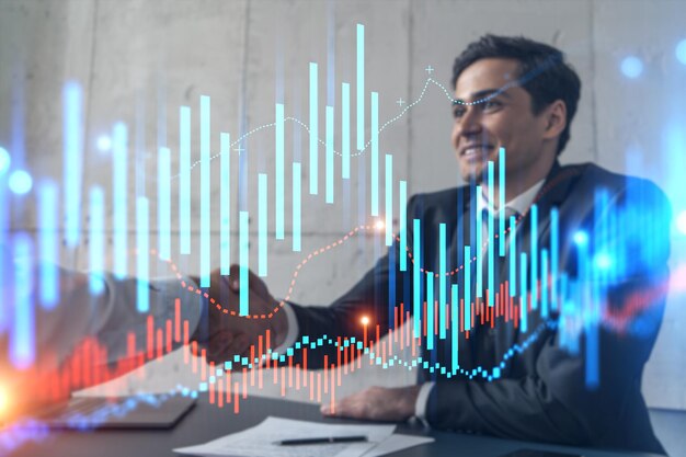 Two businessman shaking hands and forex graph hologram double exposure concept of stock market trading handshake