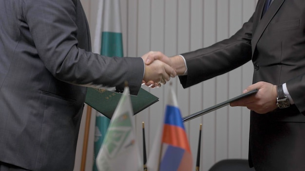 Two businessman with made a deal Two businessmen shaking hands indicating successfully made deal f