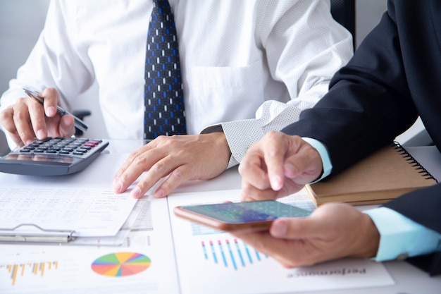 Two businessmen or analysts in a meetting room analysing on business performance