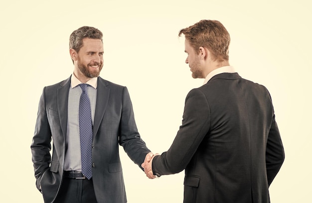 Two businessmen colleagues shaking hands after successful business deal collaboration