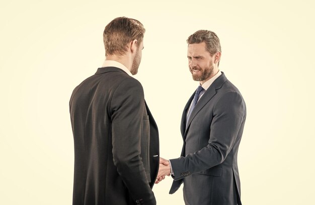 Two businessmen colleagues shaking hands after successful business deal handshake