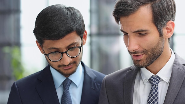 Two businessmen discussing project at meeting at office