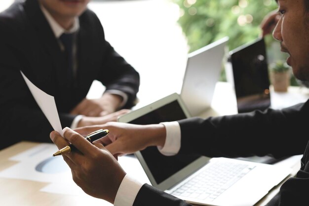 Two businessmen discussing at table in office