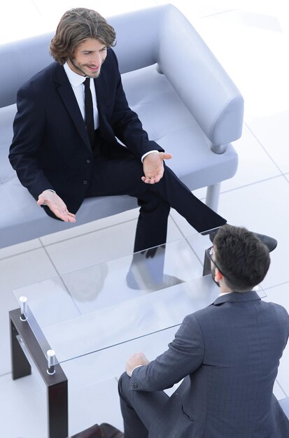 Two businessmen discussing in the workplacephoto with copy space