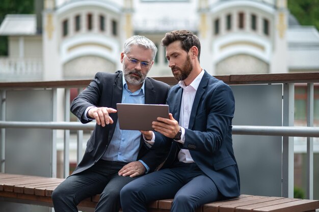 Two businessmen negotioating regarding new property and looking interested