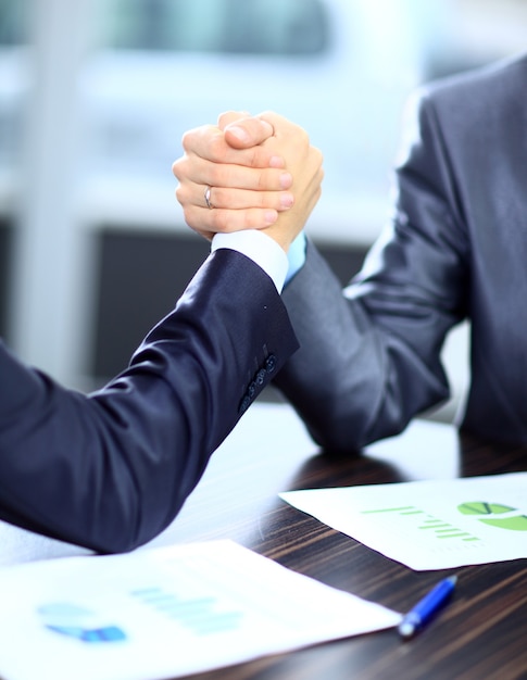 Two businessmen press hands each other