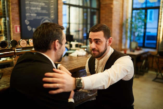 Two Businessmen Relaxing in Bar