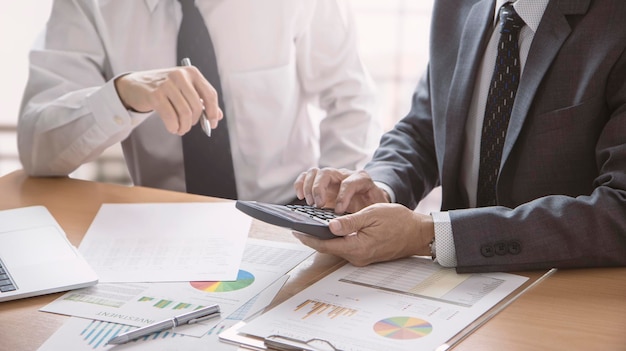 Photo two businessmen reviewing financial statements for a business performance investment risk analysis