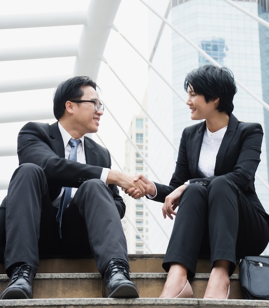 Two businessmen shake hands.