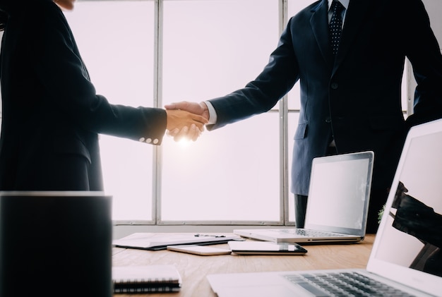 Two businessmen shake hands.