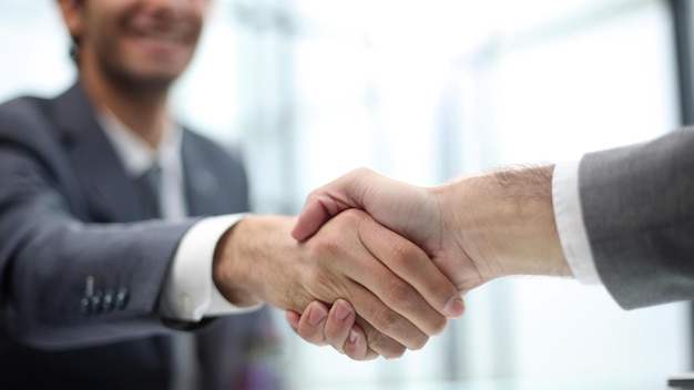 Two businessmen shaking hands at lunch meeting