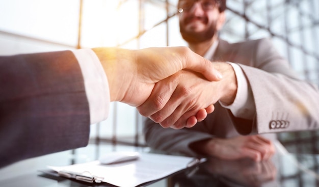 Two businessmen shaking hands at lunch meeting