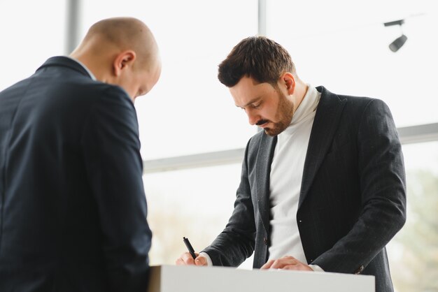 Two businessmen sign a cooperation agreement