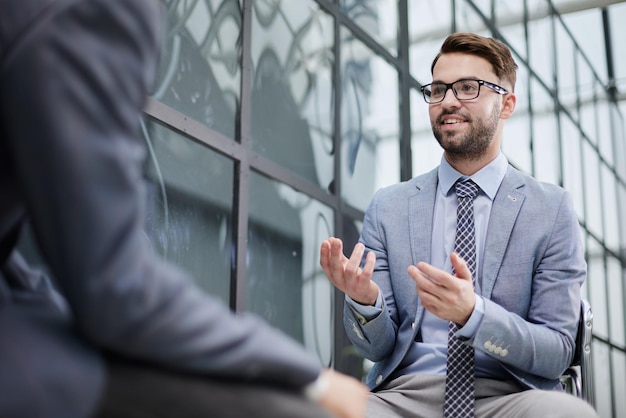 Two businessmen sitting and discussing business matters Business executives working in their office