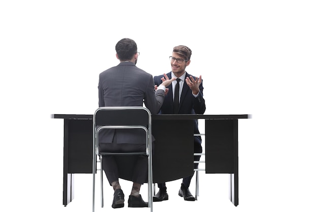 Two businessmen talking sitting at his Desk