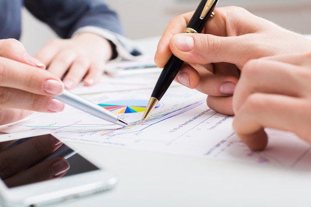 Two businesspeople with documents  together after a deal at office