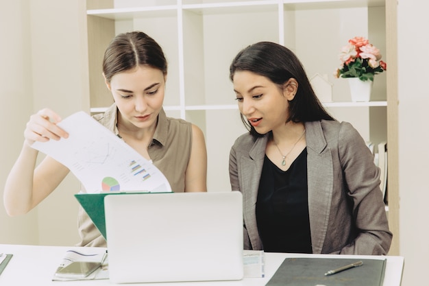 Two Businesswoman team worker co-working together mix race in the office