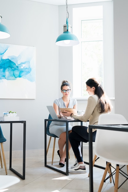 Two Businesswomen Meeting in Cafe