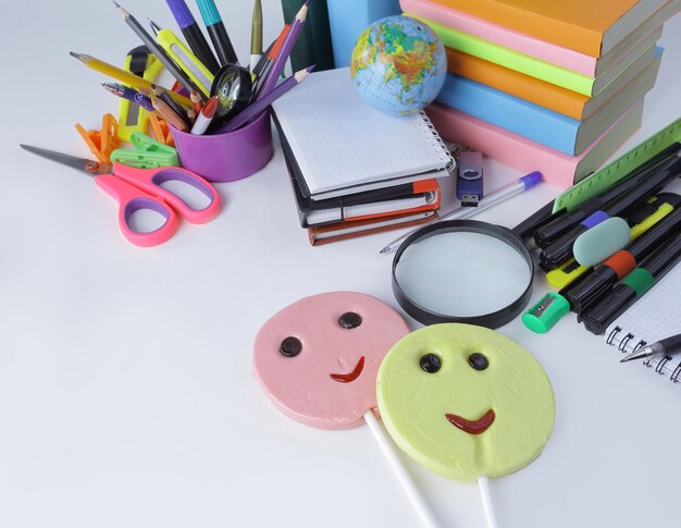 Two candy and school supplies on a white background