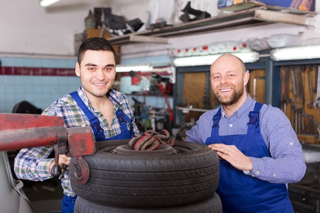 Two car mechanics at workshop