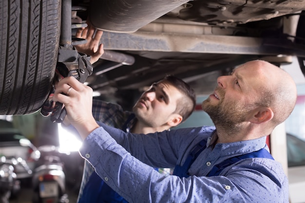 Two car mechanics at workshop