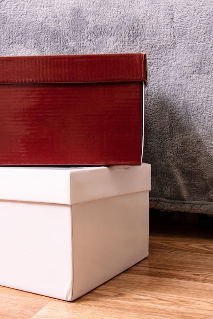 Two cardboard boxes on a wooden floor