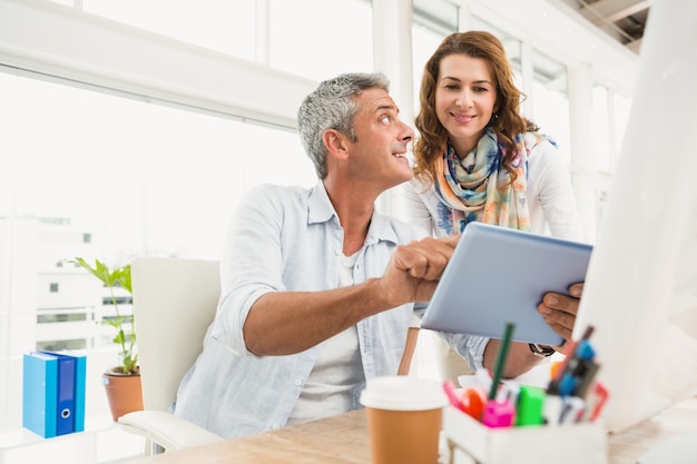 Two casual designers working with tablet