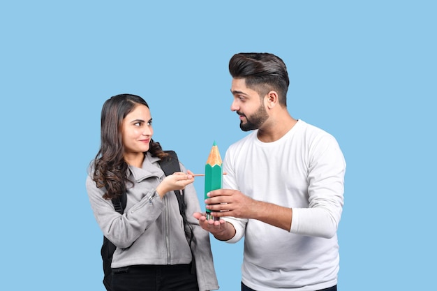 two casual students front pose isolated on blue background indian pakistani model