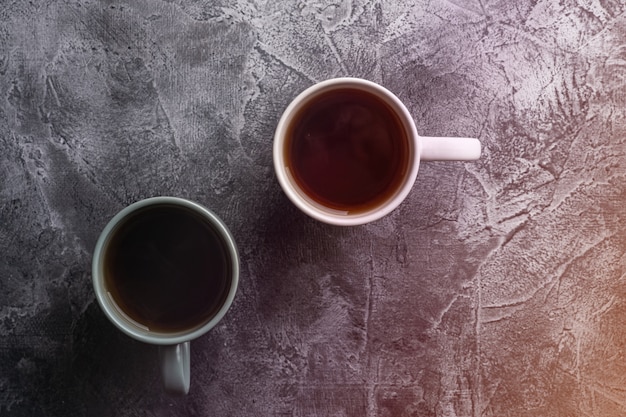 Two ceramic cups with black tea