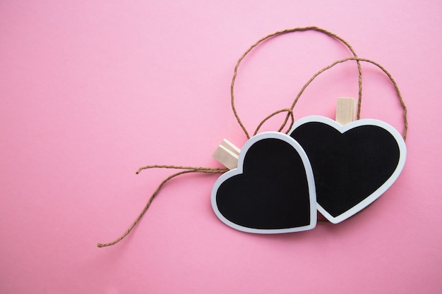 Two chalk  boards  in shape of a heart  for writing with a rope 