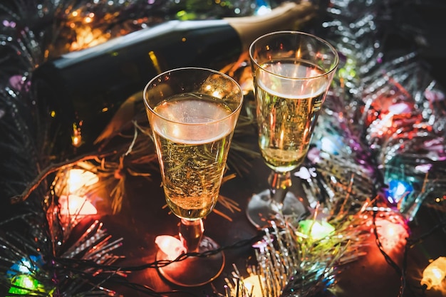 Two champagne glasses and Christmas ornaments