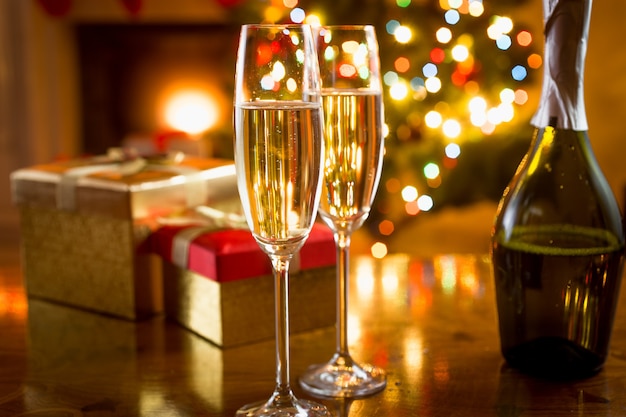 Two champagne glasses shot on background of Christmas lights