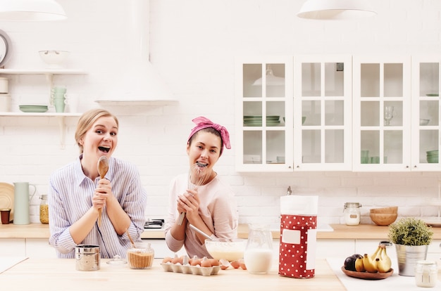 Two cheerful friends cook together. Friends Chef Cook Cooking Concept