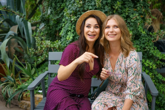 Two cheerful friends laughing in the street 